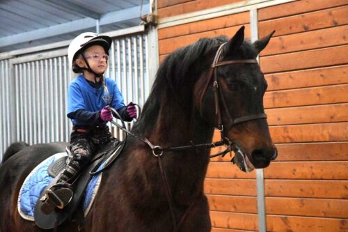 A young rider prepared for a lesson